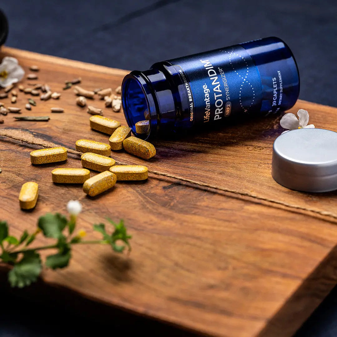 Protandim NRF2 caplets and bottle close up showing dietary supplement for oxidative stress support