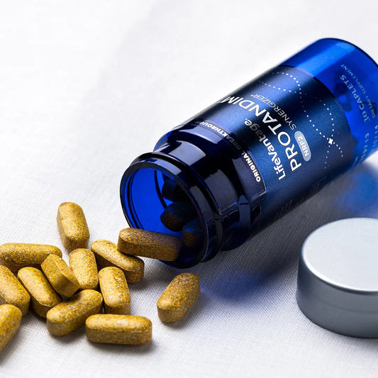 Protandim NRF2 supplement caplets spilling from blue bottle antioxidant support dietary supplement