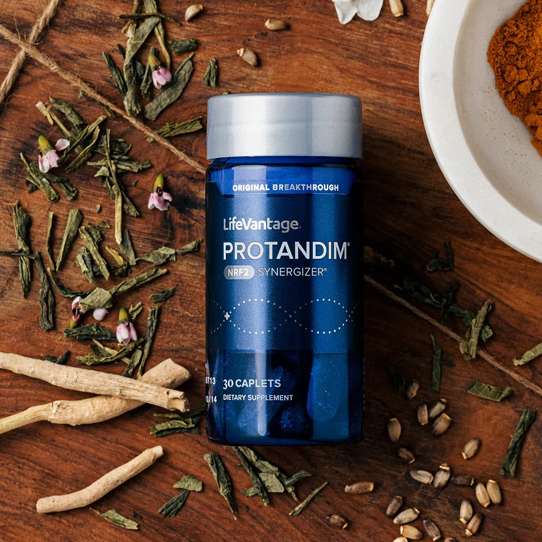 Protandim antioxidant supplement bottle with turmeric green tea and herbal blend on rustic wood surface